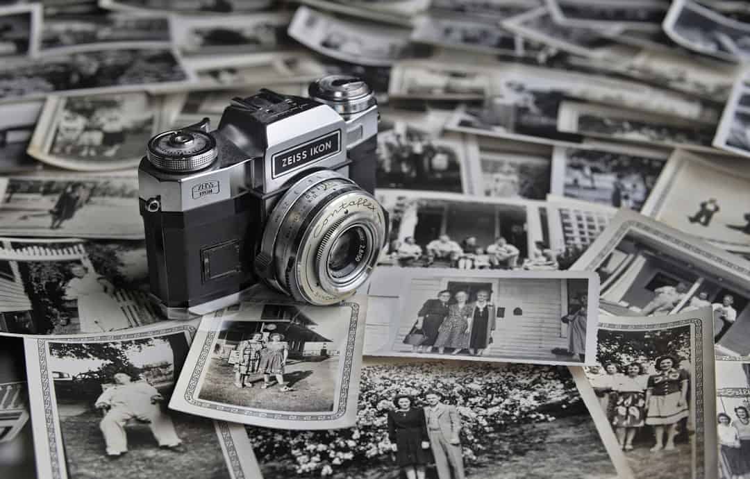 a camera sitting on top of a pile of photos